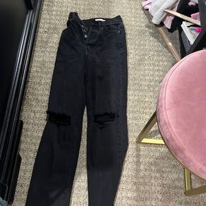 Black ripped mom jeans. Ripped at the knees